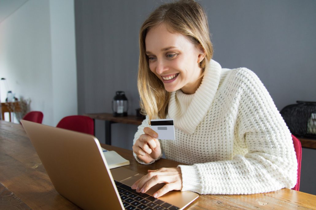Cliente realizando compra pelo notebook após receber uma mensagem no WhatsApp, representando a recuperação automática de carrinhos abandonados com aumento de conversão e resposta em tempo real.